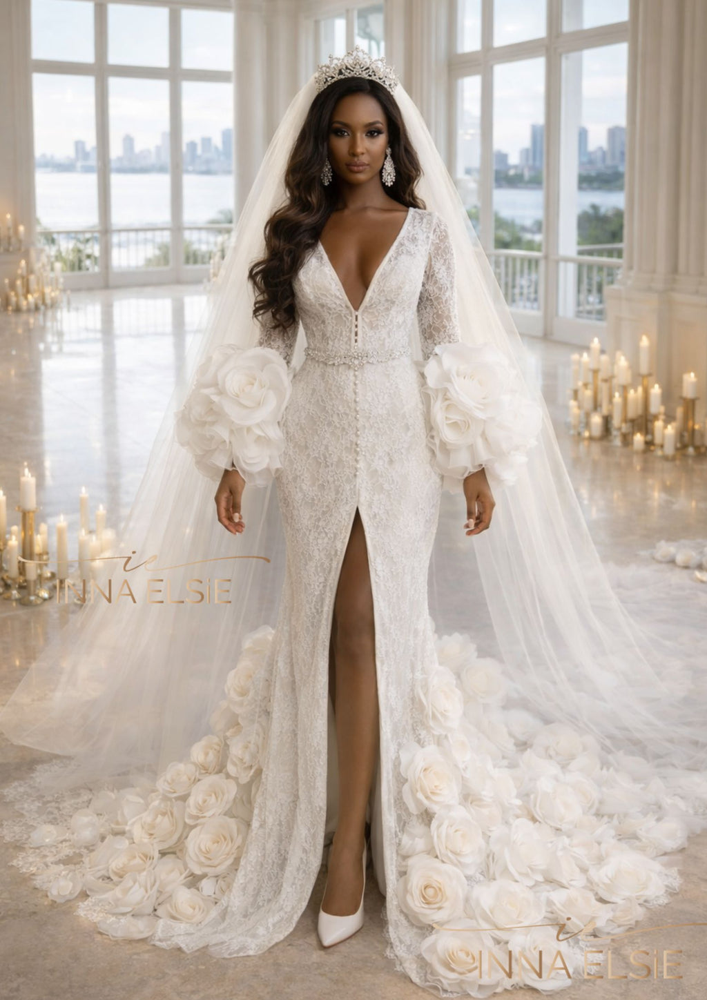 Woman in a white wedding dress with a long train and veil, standing in a room with large windows and candles.