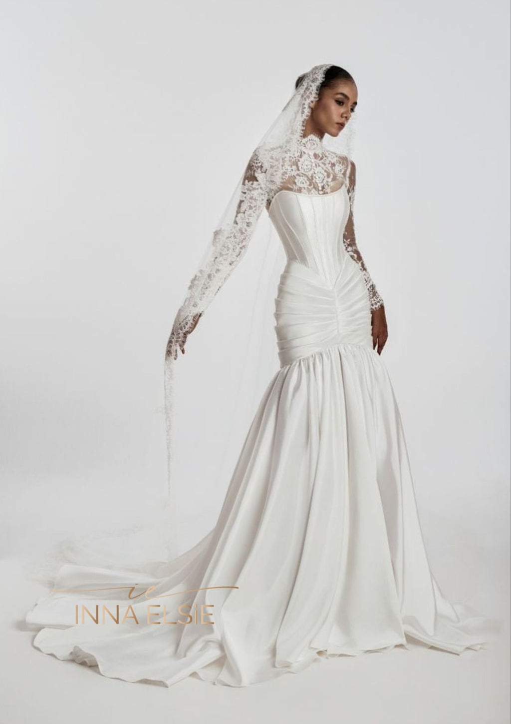 White wedding dress with lace detailing on a white background