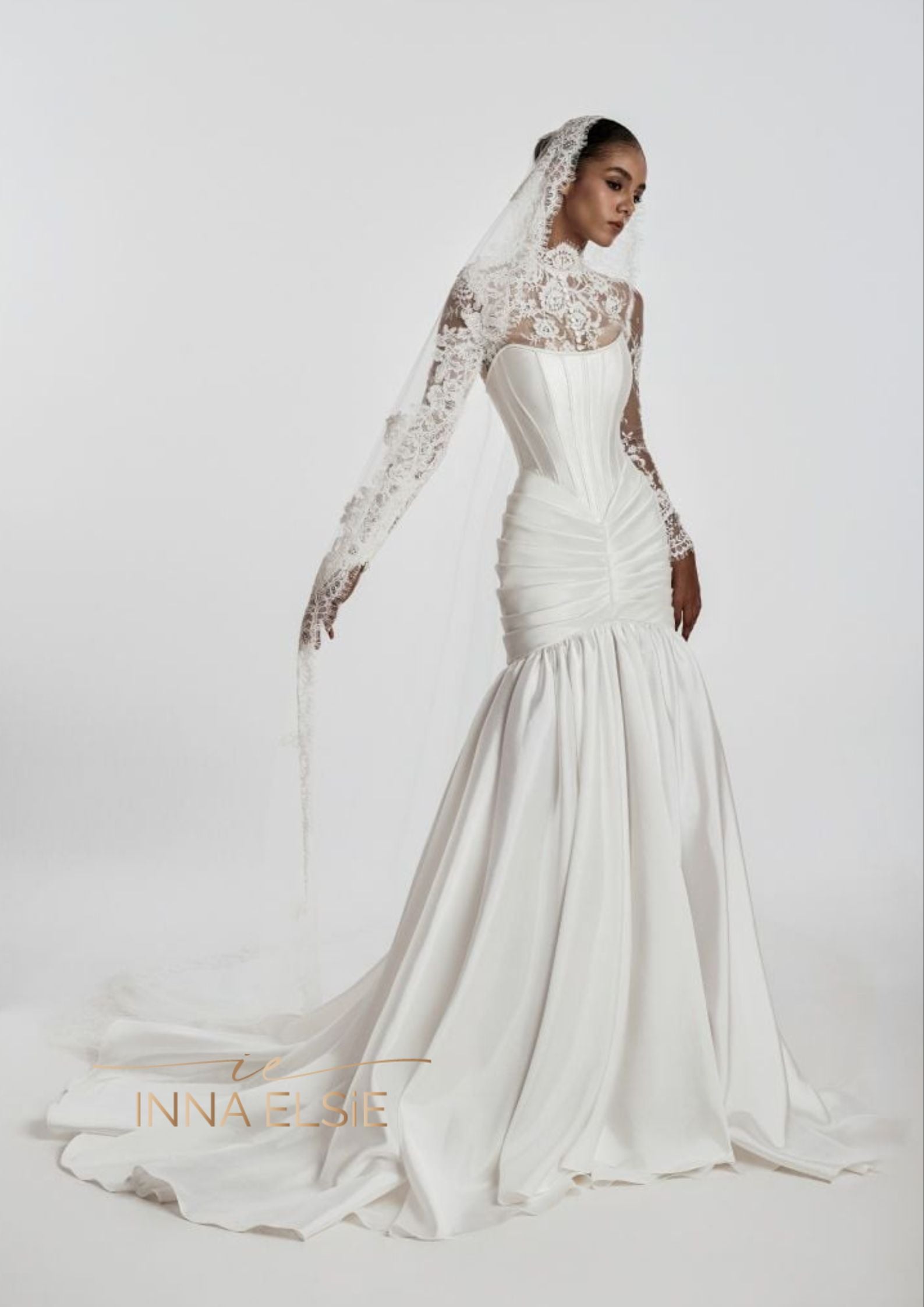 White wedding dress with lace detailing on a white background