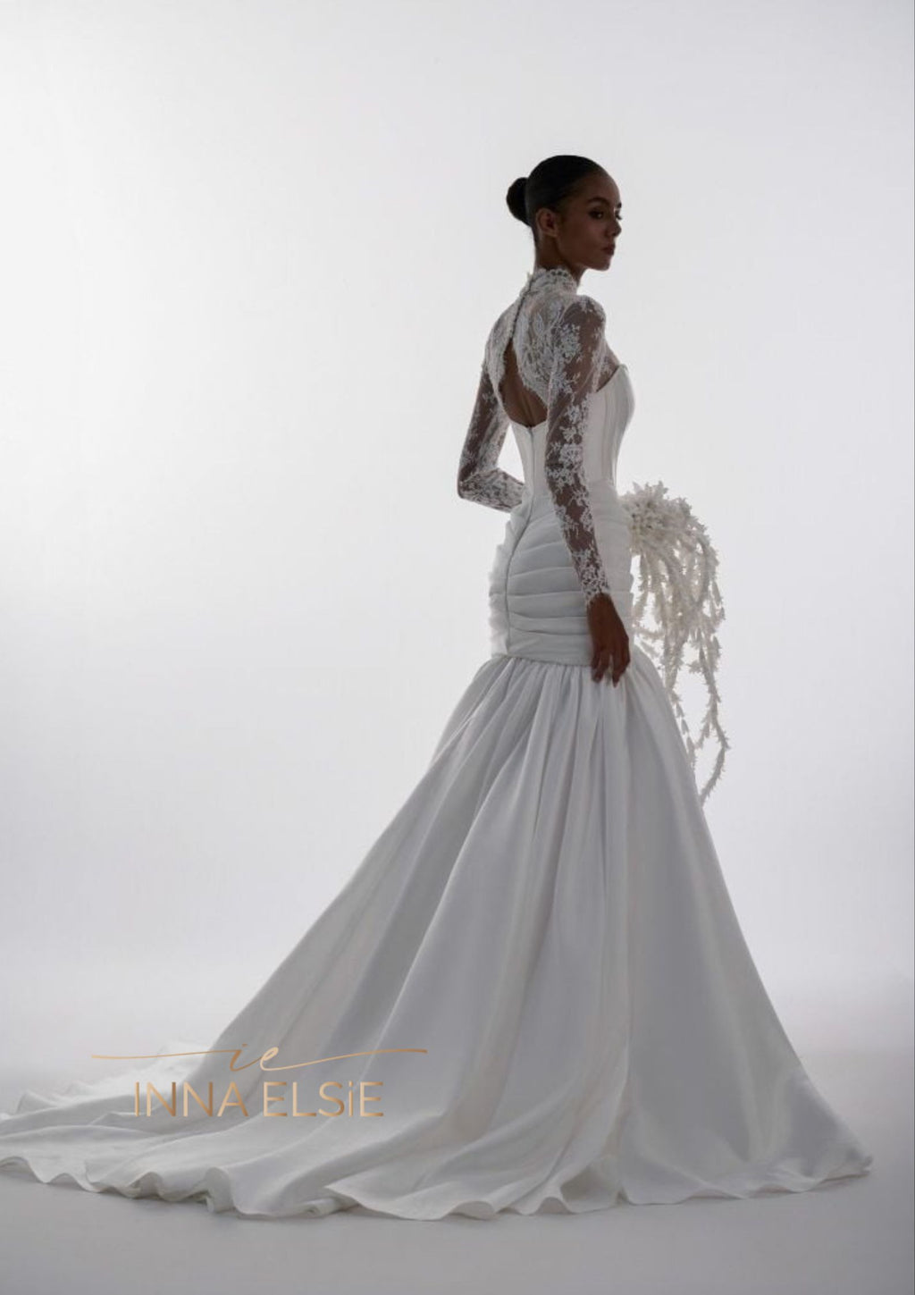 White wedding dress with lace detailing on a white background