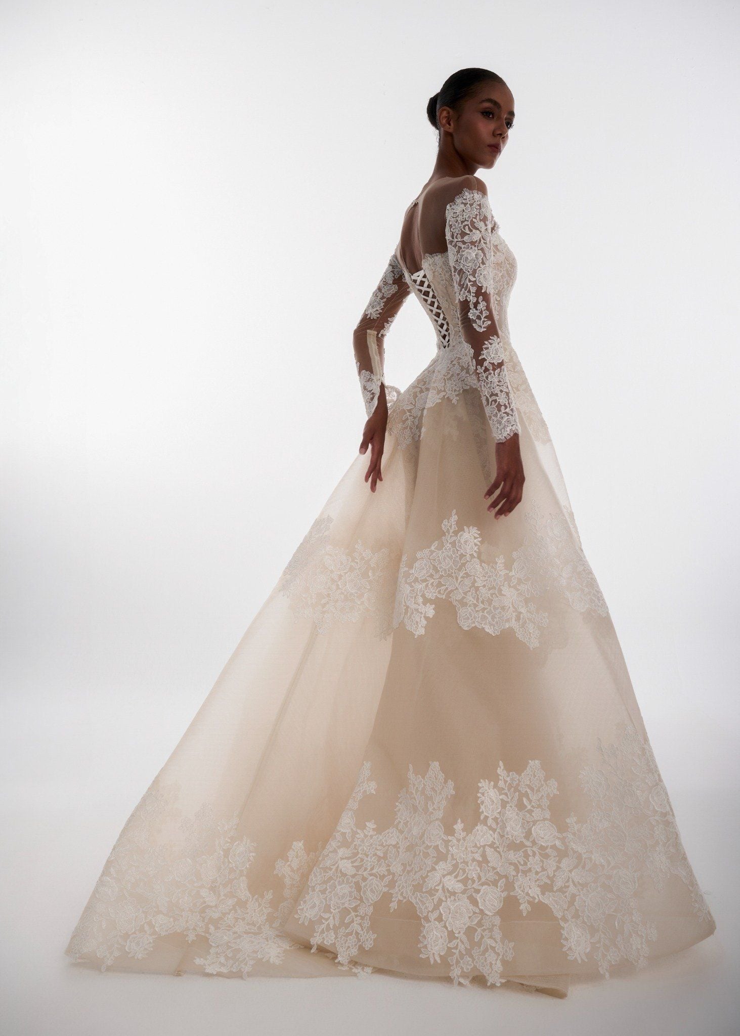 Elegant wedding dress with lace details on a white background