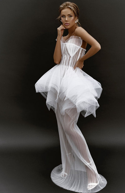 A beautiful wedding dress featuring intricate lace detailing, a fitted bodice, and a flowing tulle skirt, displayed on a mannequin against a soft, neutral background.